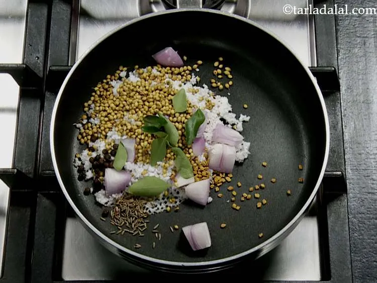 Step 4 – Also add the whole black peppercorns, fenugreek seeds and curry leaves.