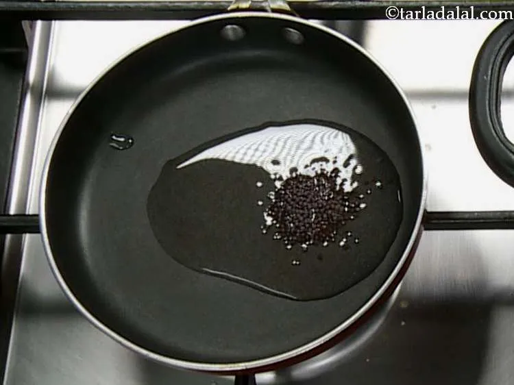 Step 28 – Heat the coconut oil in a small non-stick pan and add the mustard seeds. South …