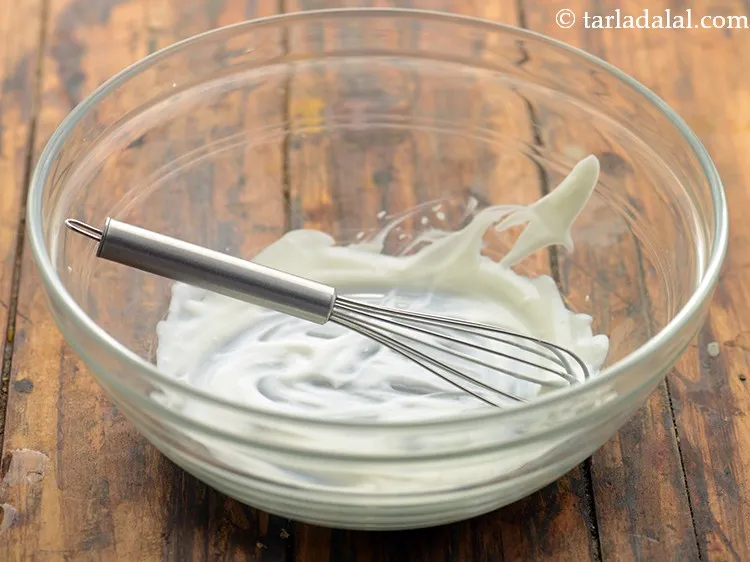 Step 11 – In a deep bowl, take curds and whisk it.&nbsp;