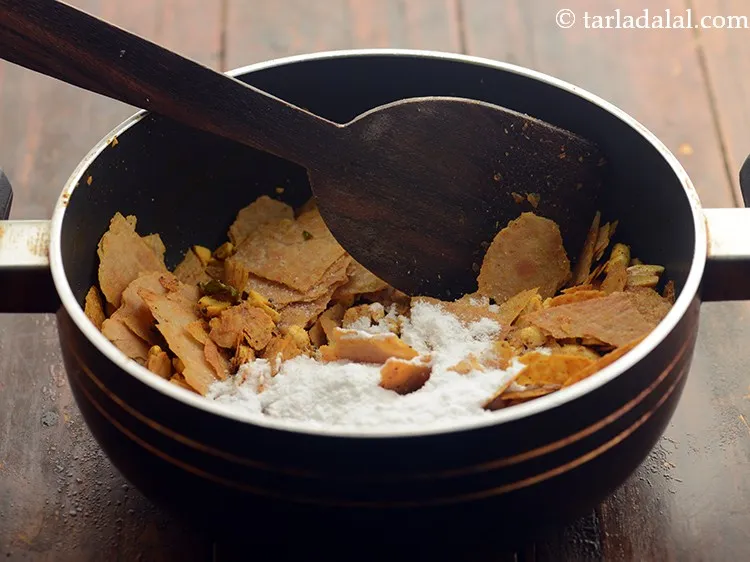 Step 13 – Switch off the flame, add the salt and powdered sugar.