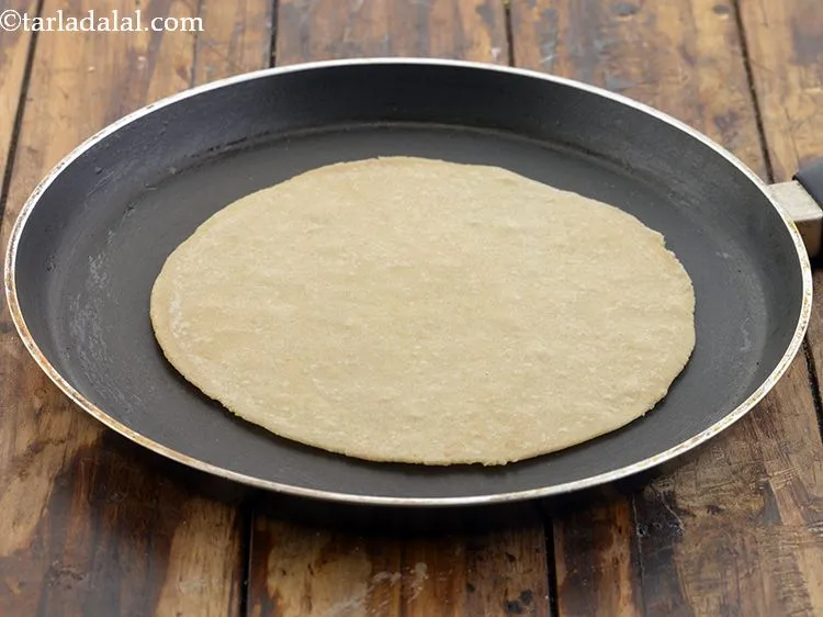 स्टेप 11 – एक नॉन-स्टिक तवे को गरम करें। उस पर बेला हुआ …