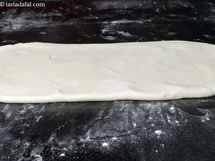 Step 20 – Roll it using a thick rolling pin into a 300 mm. &times; 150 mm. (12&rdquo; …