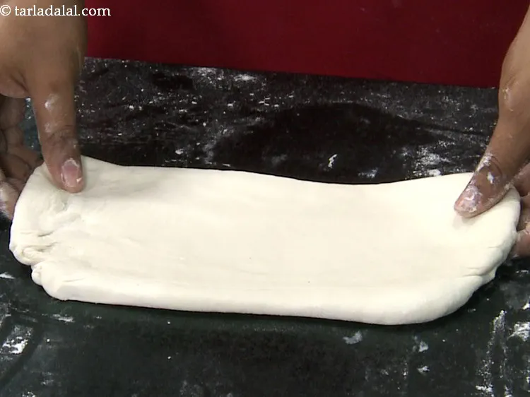 Step 23 – Roll it using a thick rolling pin into a 300 mm. &times; 150 mm. (12&rdquo; …