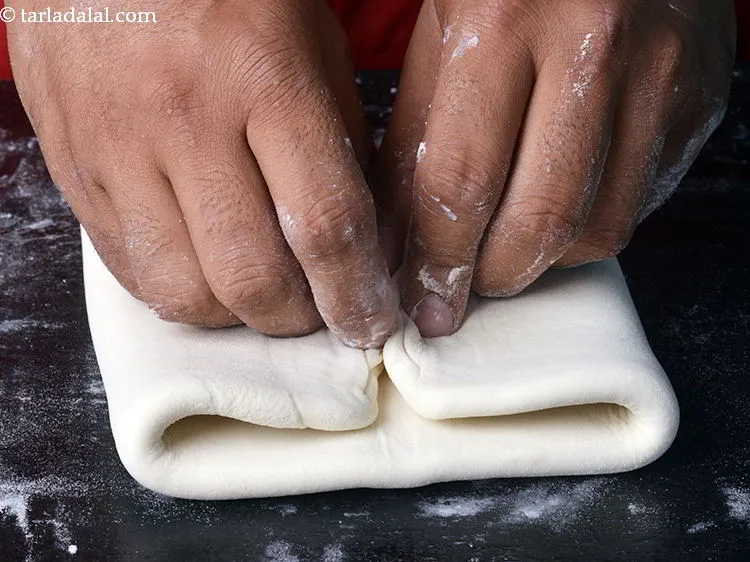 Step 24 – Lightly fold the dough in half to get an approx center and now bring both …