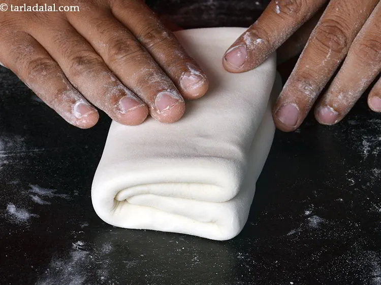 Step 25 – Press it lightly and keep the edges of the fold together. Overlap the two folded …