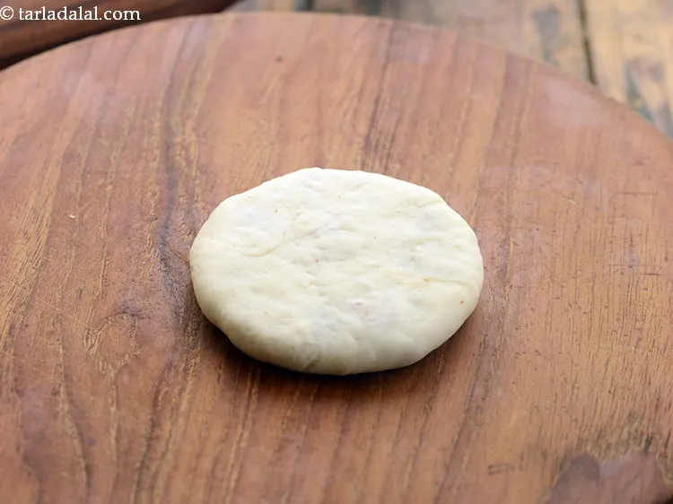 Step 31 – Roll the filled portion lightly into a 63 mm. (2&frac12;&quot;) diameter circle, while ensuring that …