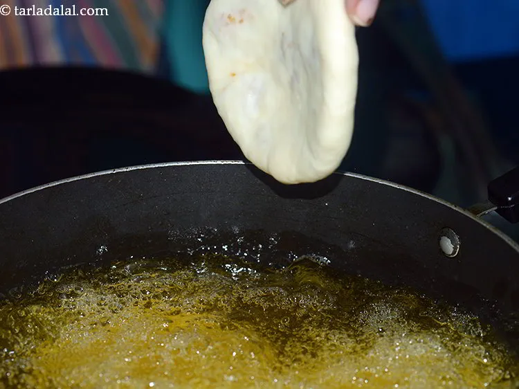 Step 34 – For frying moong dal kachori, heat the oil in a deep non-stick kadhai on a …