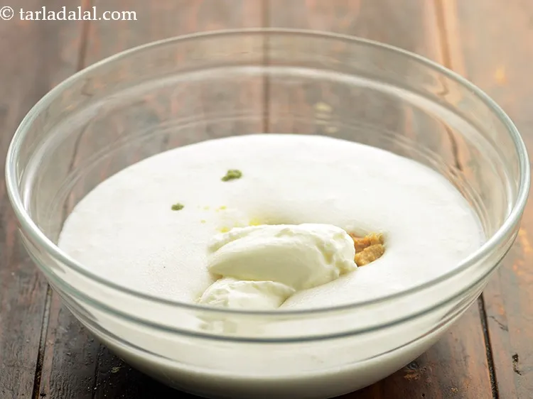 Step 6 – Add sour curd. We have used <a href="https://www.tarladalal.com/How-To-Make-Curd-Or-Dahi-At-Home-2790r" target="_blank">homemade curd</a> which will make the <strong>khatta …
