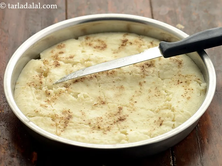 Step 19 – Cool slightly and cut <strong>instant khatta dhokla</strong> into diamond-shaped equal pieces.