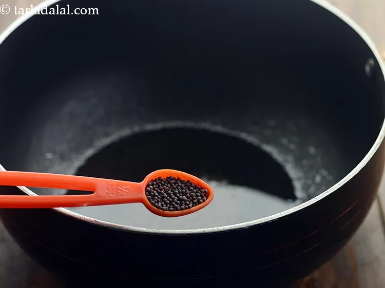 Step 14 – Once the oil is hot, add the mustard seeds.