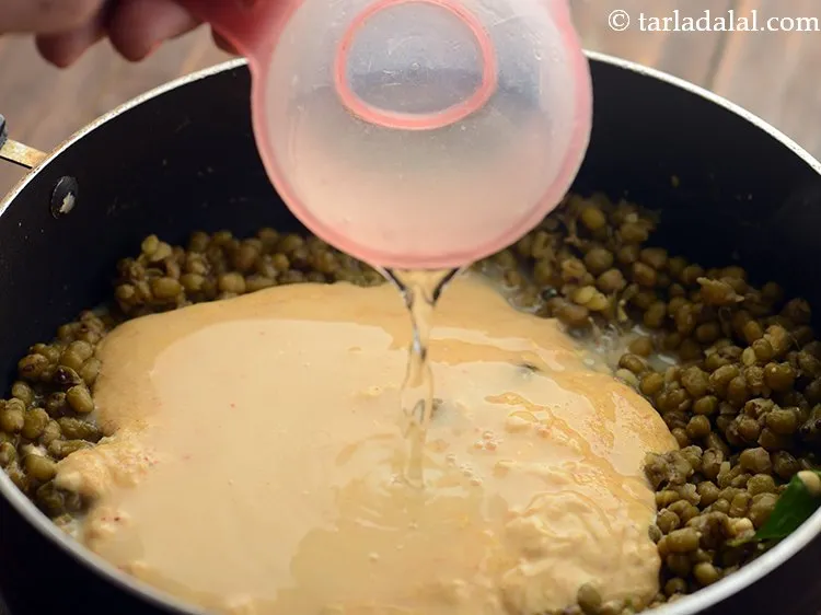 Step 22 – Add salt and 1 cup of water to adjust the consistency of <strong>Gujarati Khatta Mag</strong>. …