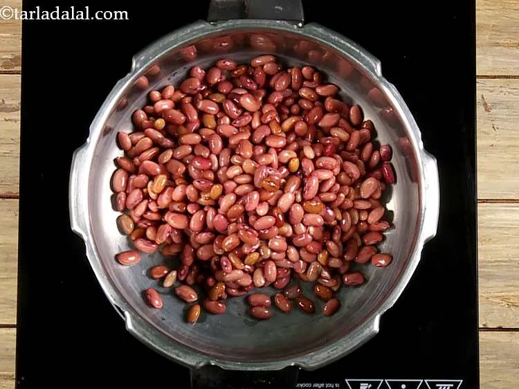Step 9 – In a pressure cooker put soaked rajma.