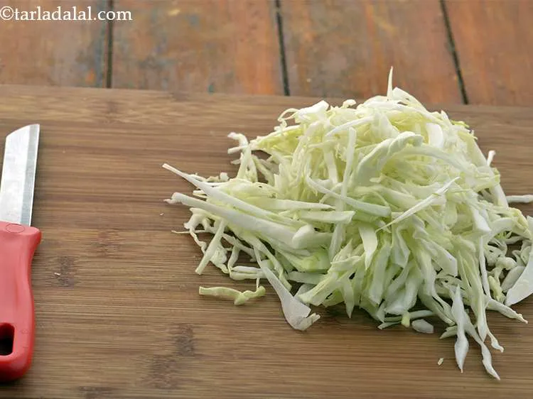 Step 2 – To make&nbsp;<strong>Kobi Batata Nu Shaak (Aloo Patta Gobhi)</strong><strong>,&nbsp;</strong>first&nbsp;using a sharp knife, cut the cabbage into …