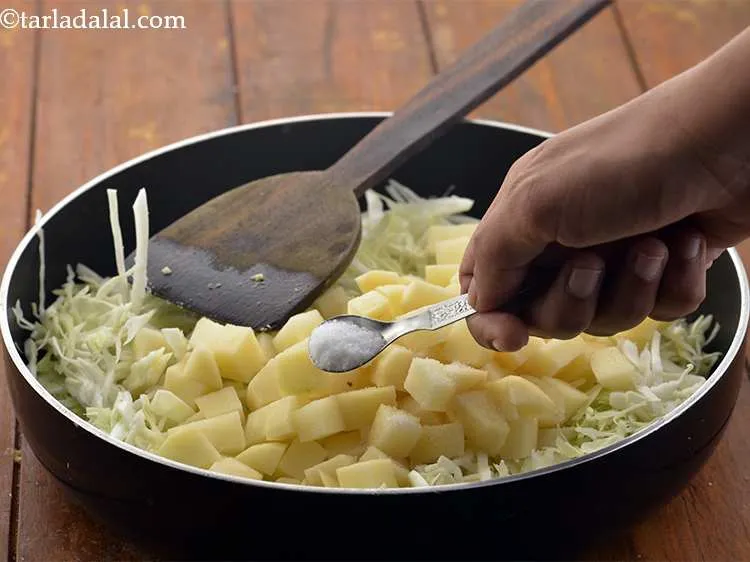 स्टेप 13 – नमक डालें। बहुत से लोग <strong>आलू पत्तागोभी की सब्जी</strong> में …