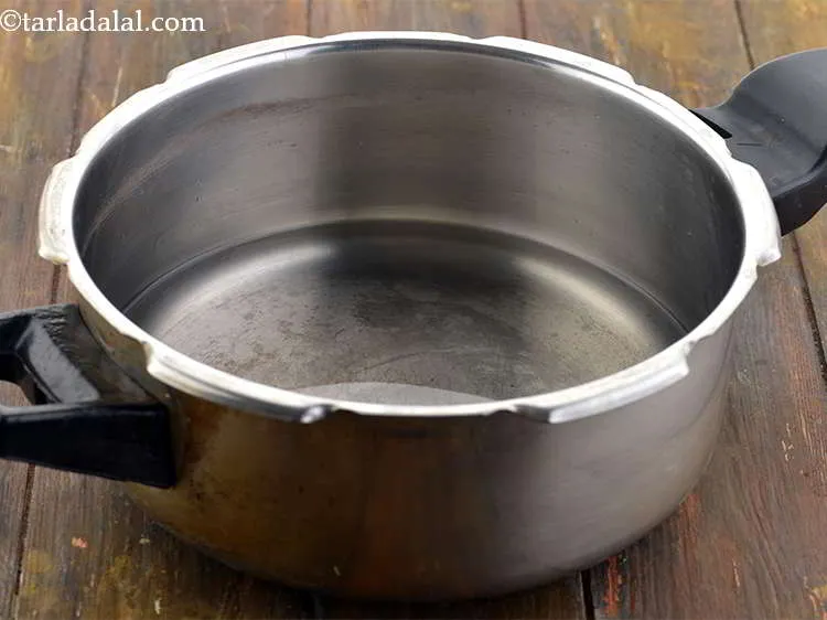 Step 8 – Next add 2 cups of water in a pressure cooker.