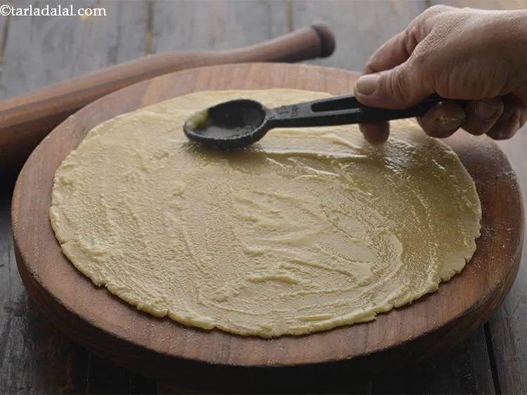 Step 12 – Spread 1 tsp of ghee evenly over it. The more oil or ghee you use …