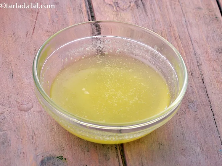 Step 7 – For preparing the dough for <strong>homemade ladi pav</strong>, in another bowl, take oil. Add butter. …