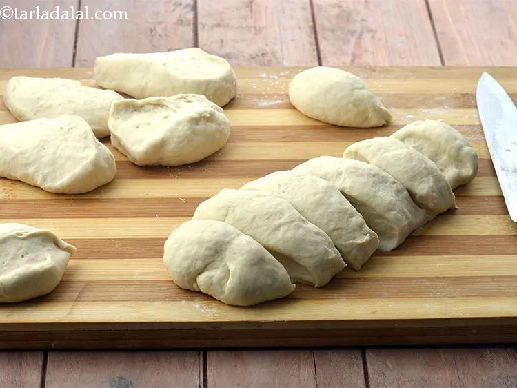 Step 25 – For baking the eggless ladi pav, divide the pav bun dough into 12 equal portions …