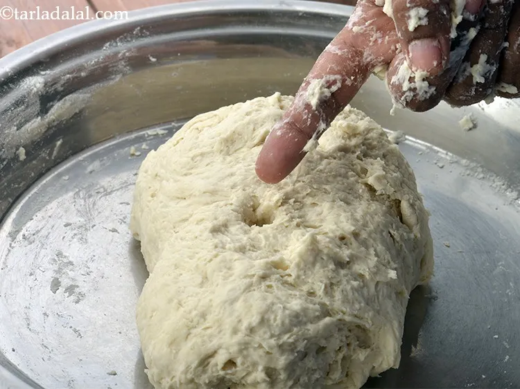 स्टेप 13 – एक बार आटा गूंधने के बाद, उंगलि को आटे में …
