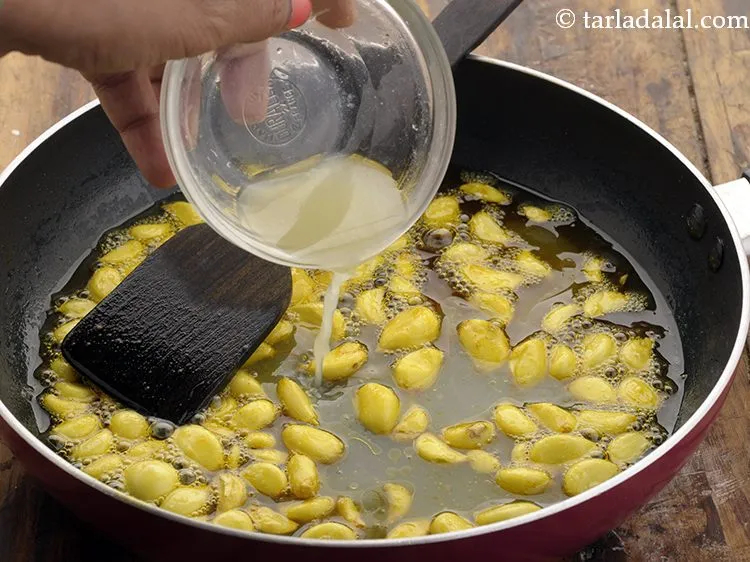 Step 12 – Add lemon juice to increase the shelf life of <strong>lahsun ka achar</strong>.
