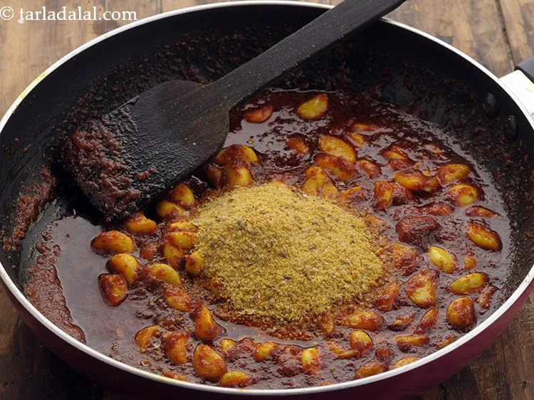 Step 18 – Switch off the flame, add the masala powder to the cooked garlic mixture.