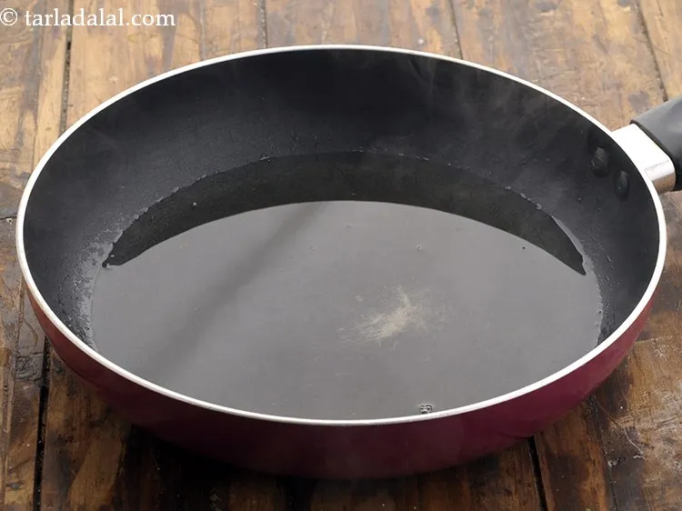 Step 8 – To make&nbsp;<strong>lahsun ka achaar recipe | Punjabi lehsun ka achar | garlic pickle |</strong>&nbsp;heat the …