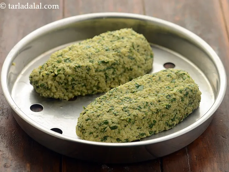 Step 21 – Arrange both the muthia rolls on a greased sieve. Keep proper distance between both the …