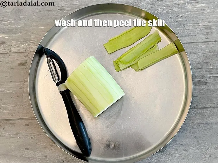 Step 6 – Wash and then peel the skin off the lauki (bottlegourd).