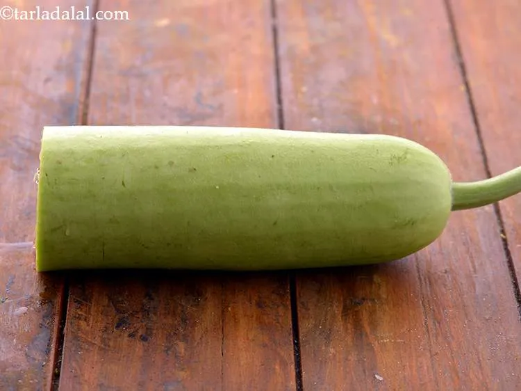 Step 3 – To begin making the <strong>Lauki ka Raita recipe (Dudhi Raita)</strong>, wash and peel a medium …