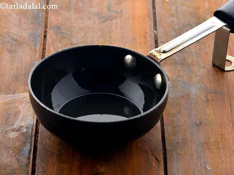 Step 18 – For the tempering of <strong>bottle gourd raita (Dudhi Raita)</strong>, heat the oil in a small …