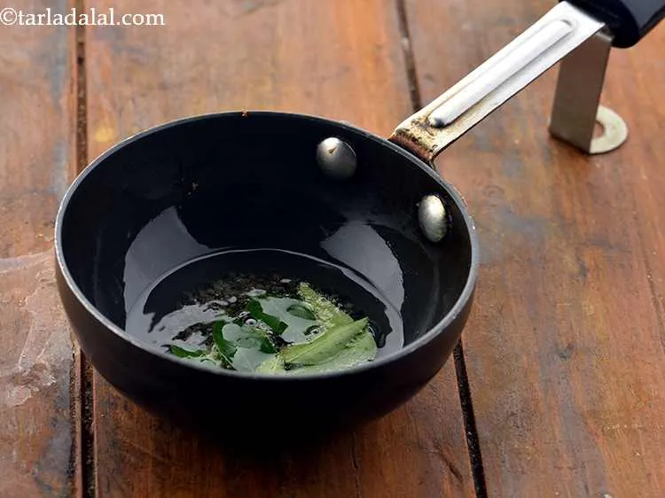 Step 20 – When the seeds crackle, add the curry leaves and saut&eacute; on a medium flame for …