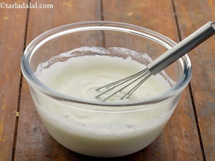 Step 6 – In a small bowl, take curd and whisk it using a hand whisk. Keep aside. …