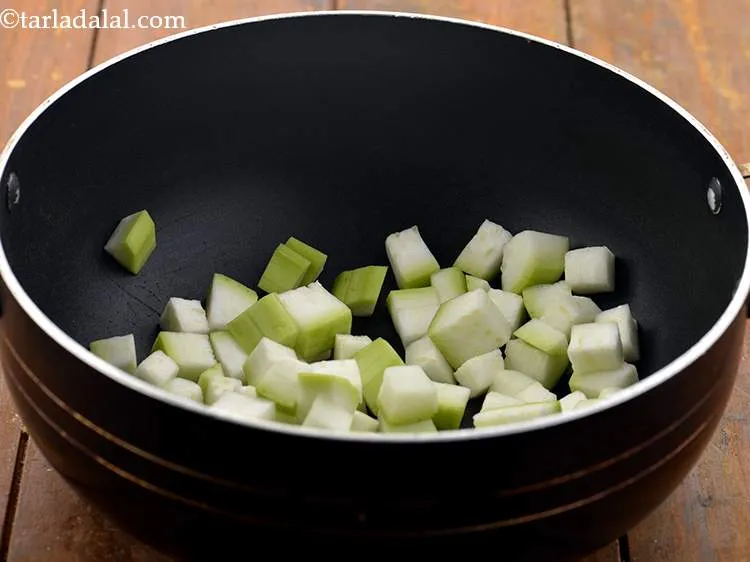 Step 8 – For making the <strong>lauki raita( Dudhi Raita)</strong>, in a deep non-stick pan, take the chopped …