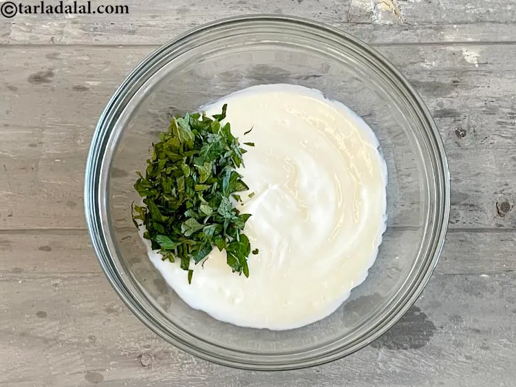 Step 12 – Add 4 tbsp&nbsp;<a href="https://www.tarladalal.com/glossary-chopped-mint-788i">chopped mint leaves (phudina)</a>.