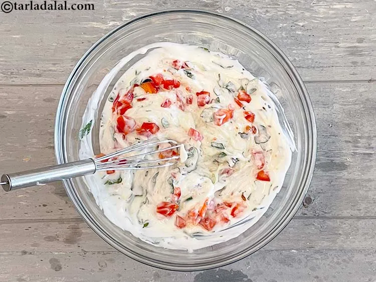 Step 18 – Whisk <strong>lauki aur tomato ka raita&nbsp;</strong>well.