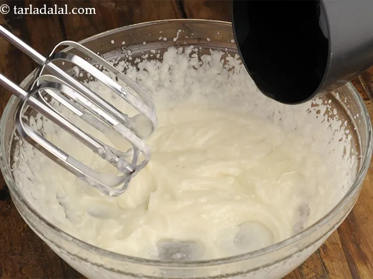 Step 10 – Add remaining &frac12; cup oil and blend with the help of electric beater till it …