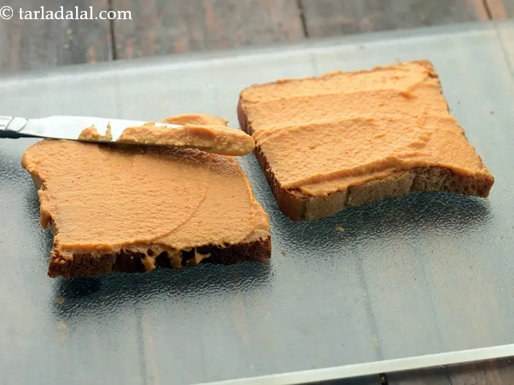 Step 18 – Put 1 tbsp of the <strong>spicy garlic hummus</strong> on each toasted bread slice.&nbsp;Spread the hummus …