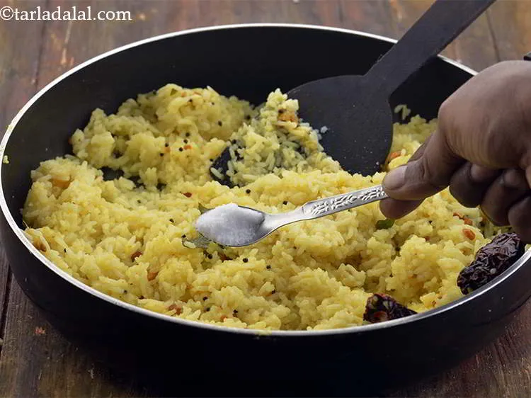 Step 22 – Add the salt to the&nbsp;<strong>Lemon Rice, South Indian Lemon Rice</strong>. Adjust the quantity of lemon …
