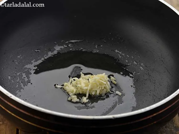 Step 6 – Once the oil is hot, add the garlic.