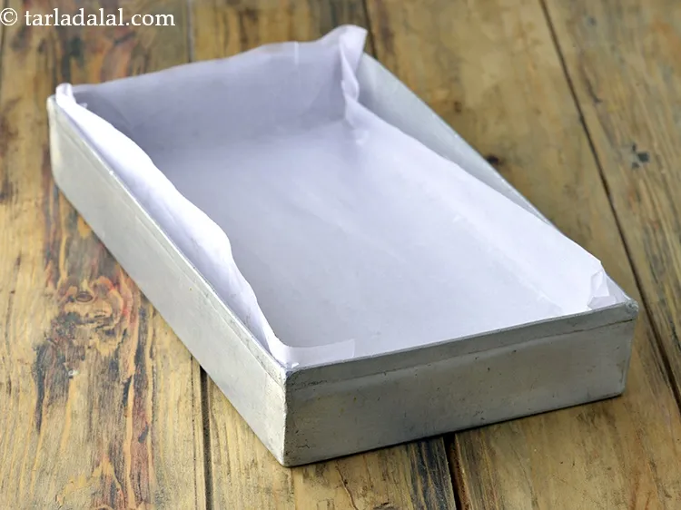 Step 8 – Pour the mixture in the aluminium tray lined with butter paper.