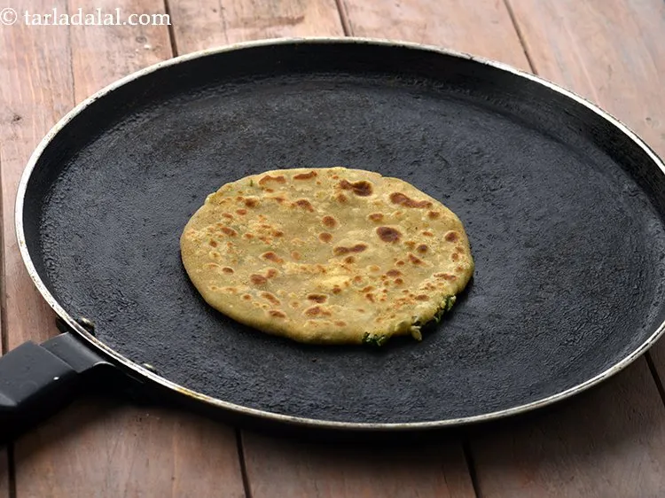 Step 18 – Heat a non-stick tava (griddle) and cook <strong>low fat paneer and green peas stuffed paratha …