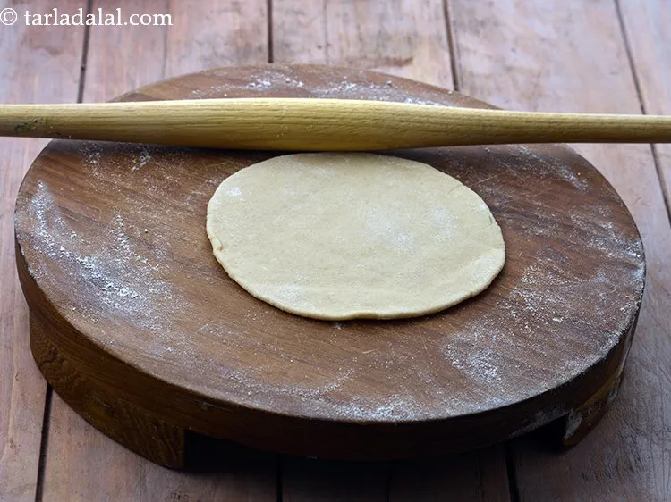 Step 14 – Roll a portion of dough into a 125 mm. (5&rdquo;) diameter circle using a little …