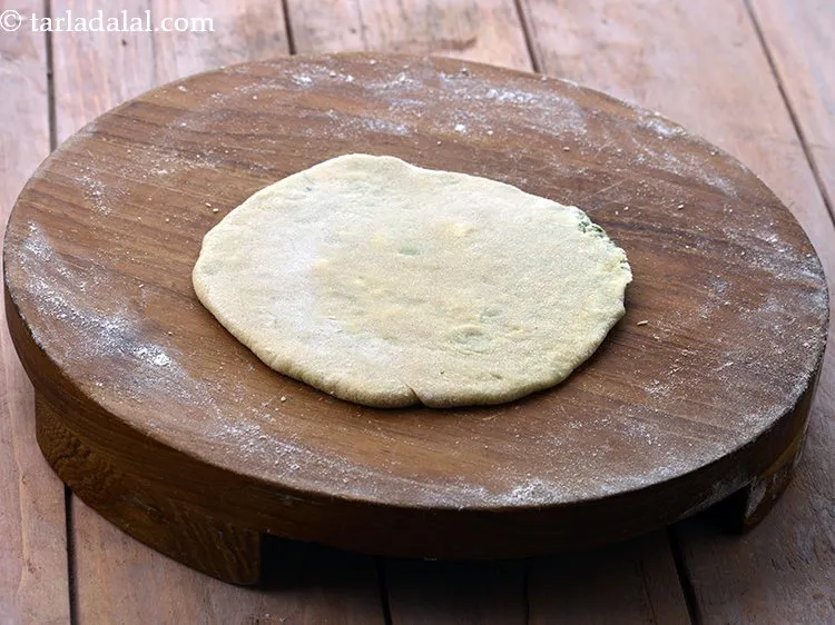 Step 17 – Press it lightly to seal the stuffing, flatten the dough and roll out again into …