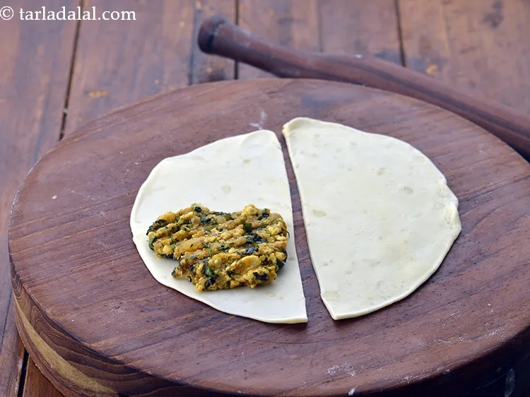 Step 53 – Place one portion of the stuffing at one end on a halve and spread it …