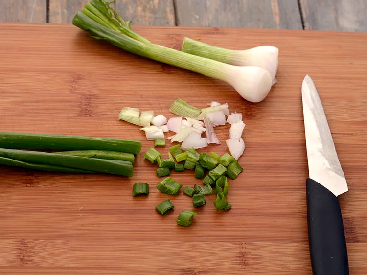 Step 33 – Add &frac12; cup chopped spring onions (whites and green).
