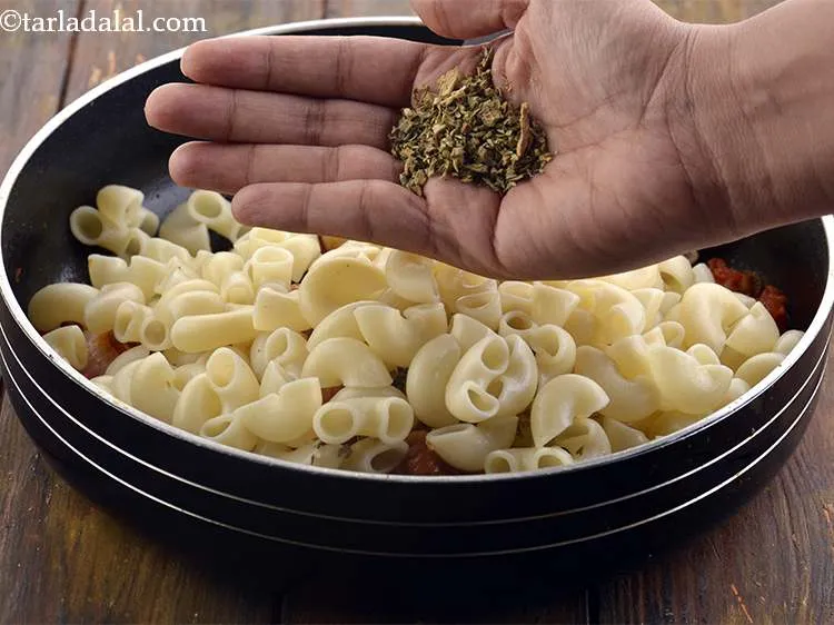 Step 22 – Then, add the cooked macaroni and the oregano. It imparts a warm peppery flavour and …