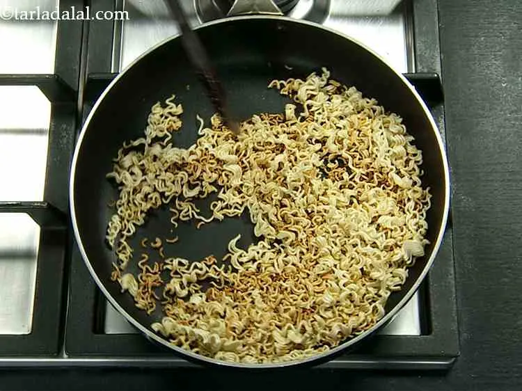Step 4 – Dry roast the coarsely crushed maggi noodles in a broad non-stick pan on a medium …