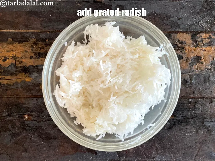 Step 10 – Add 4 cups&nbsp;<a href="https://www.tarladalal.com/glossary-grated-radish-953i">grated radish (mooli)</a>.