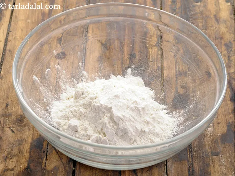 Step 20 – For the dough, add 1 cup&nbsp;<a href="https://www.tarladalal.com/glossary-plain-flour-maida-188i">plain flour (maida)</a> in a deep bowl.&nbsp;