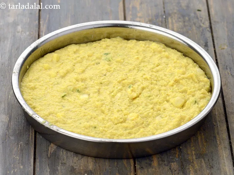 Step 18 – Pour the batter into a greased 175 mm. (7&rdquo;) diameter thali.